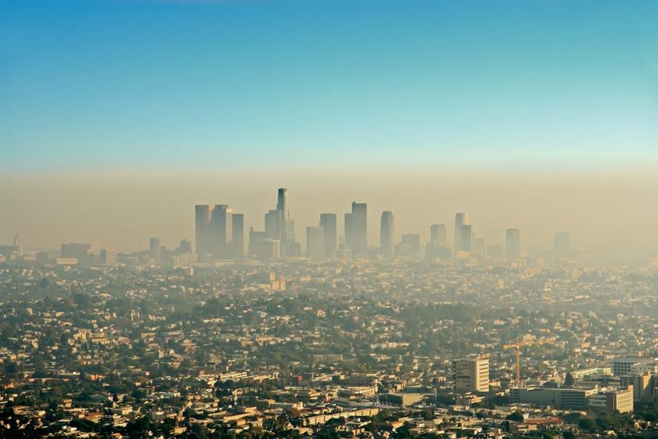 Wide shot of the downtown Los Angeles skyline bathed in smog. View from Griffith Park - Getty